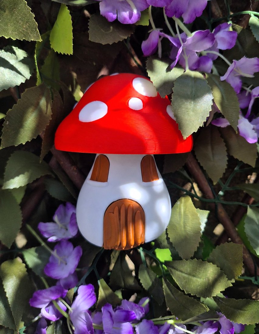 Mushroom fairy house nestled among leaves and flowers